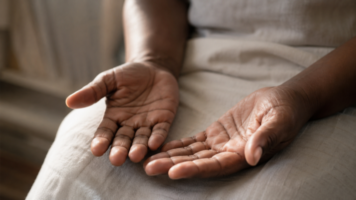Person's hands resting open and relaxed in their lap — fight flight freeze stress response and the nervous system